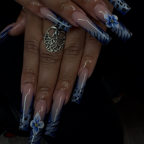 Extra-long navy and black stiletto acrylics with 3D blue flowers