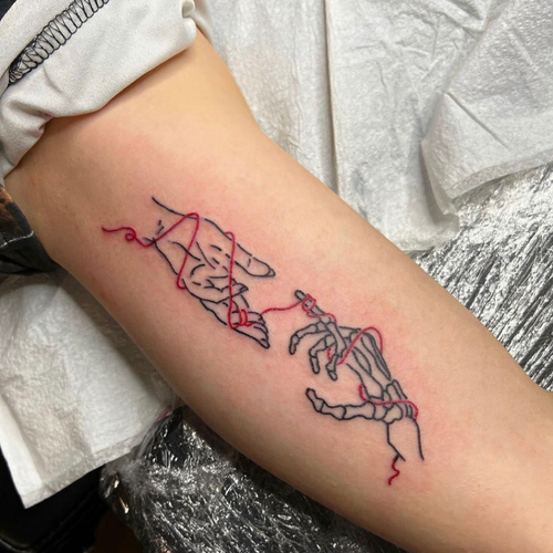 Creation of Adam with red line (soulmates) inner bicep 