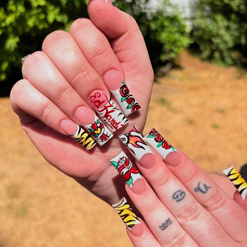 Long square acrylics with tattoo-style roses, flames and tiger stripes