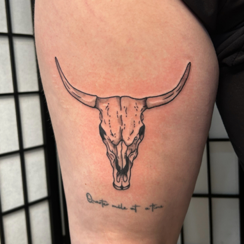 A Longhorn leg piece, featuring a bold and powerful longhorn design. This tattoo showcases the majestic horns and rugged details, creating a striking and memorable piece that fits around the leg beautifully.