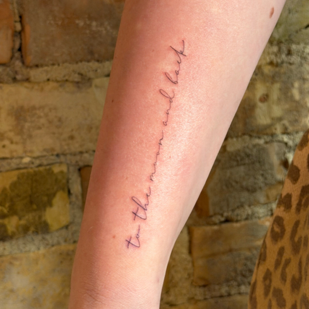 Long Script Tattoo at Por Vida in St. Louis Park, MN