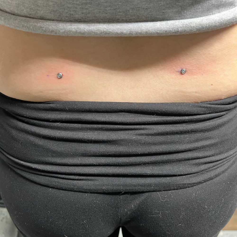 Back Dimples (dermal Piercings) at Calico Creek Tattoo Co. in Wichita, KS