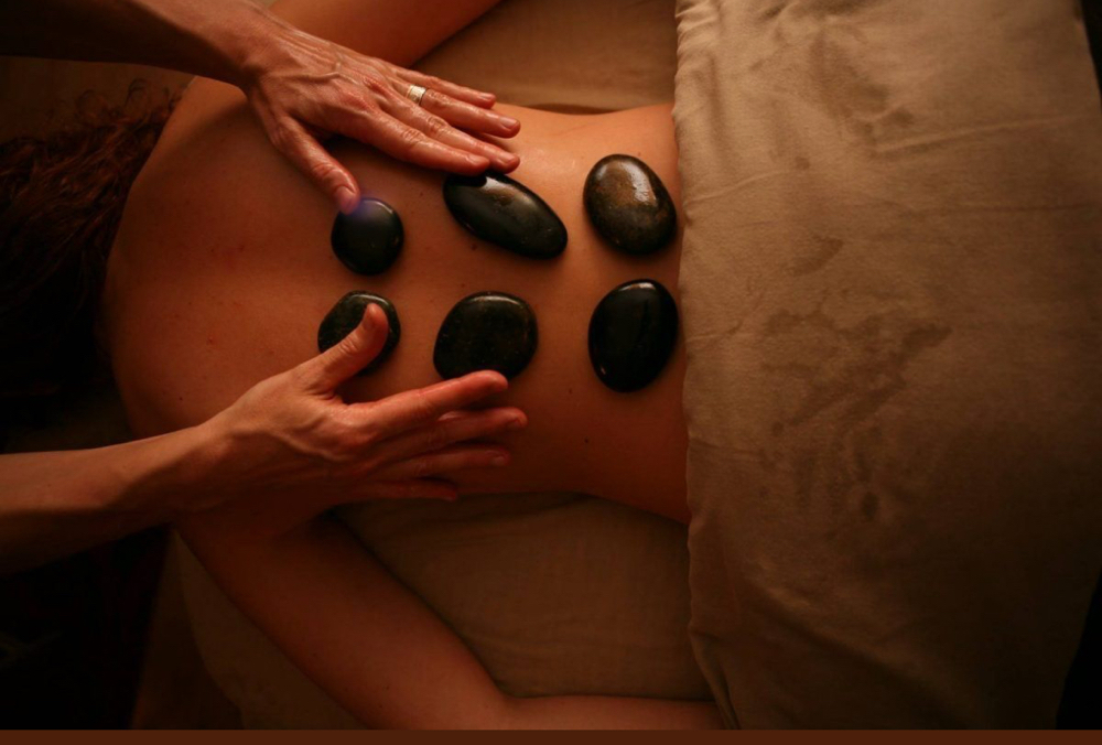 Hot Stone Massage at Women’s Wellness Massage Therapy in Syracuse, NY