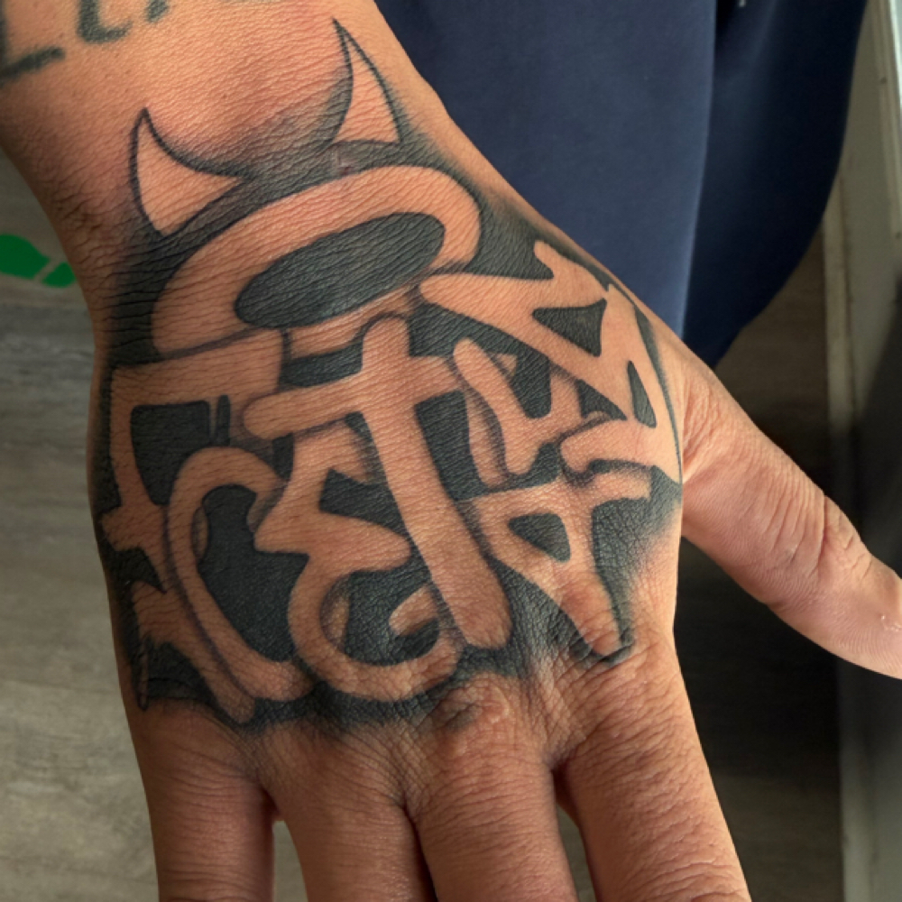 Hand tattoo at Rilla Tatted it in fayetteville, NC