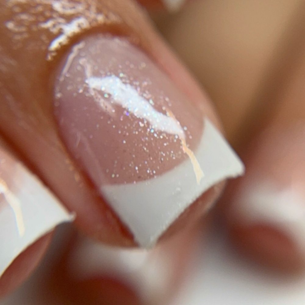 Acrylic overlay with xs white tips at Rise & Bloom Nails Spa in Bakersfield, CA