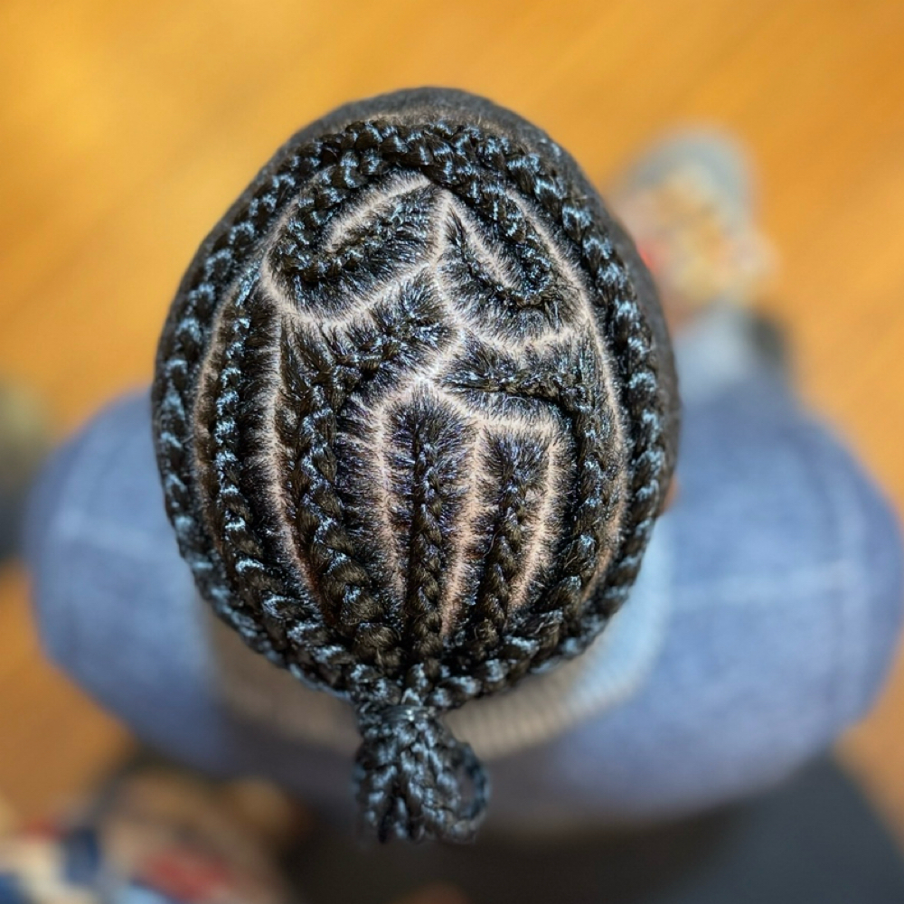 Braided Manbun at Unique Braids, Locs & Twists in Appleton, WI