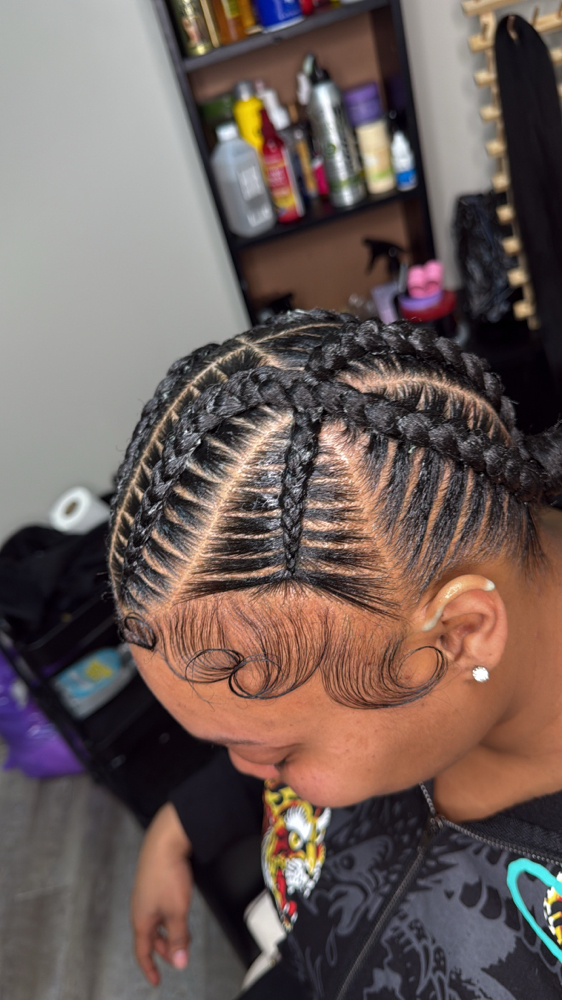 4 Cross Stitch Braids With Bun at Faith TheBraider in Milwaukee, WI