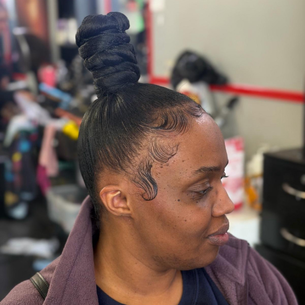 Sleek knot bun ponytail at Alizah’s Hair Salon in Indianapolis, IN
