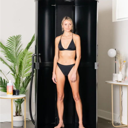Spray tanning session at Ember & Ivy Salon in Henderson, TN