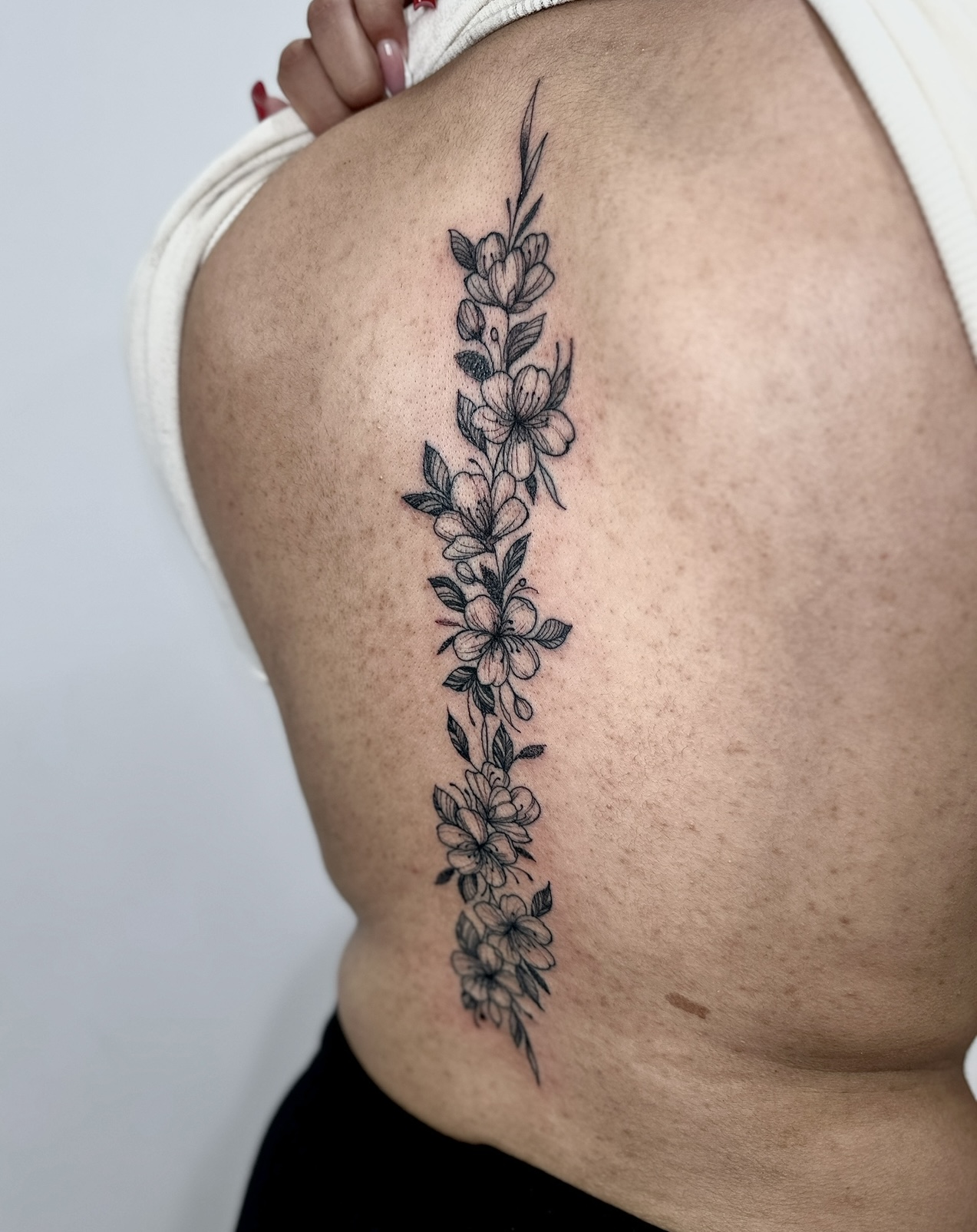 Minimal Floral Spine Tattoo