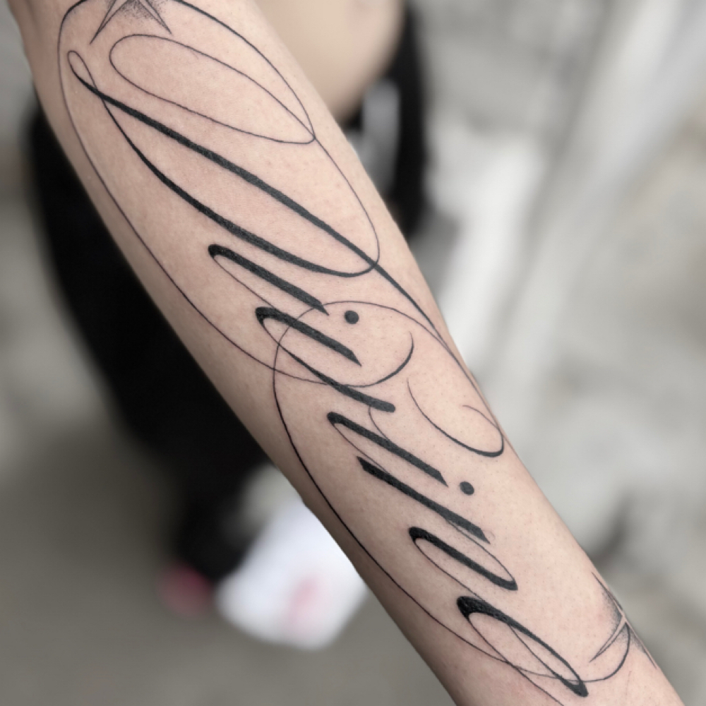Large Scale Script at Kootsoo Tattoos in Reno, NV