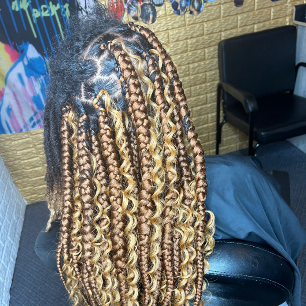 Knotless braids over locs at Locs O’ Luv by Nola in Bloomington, IL