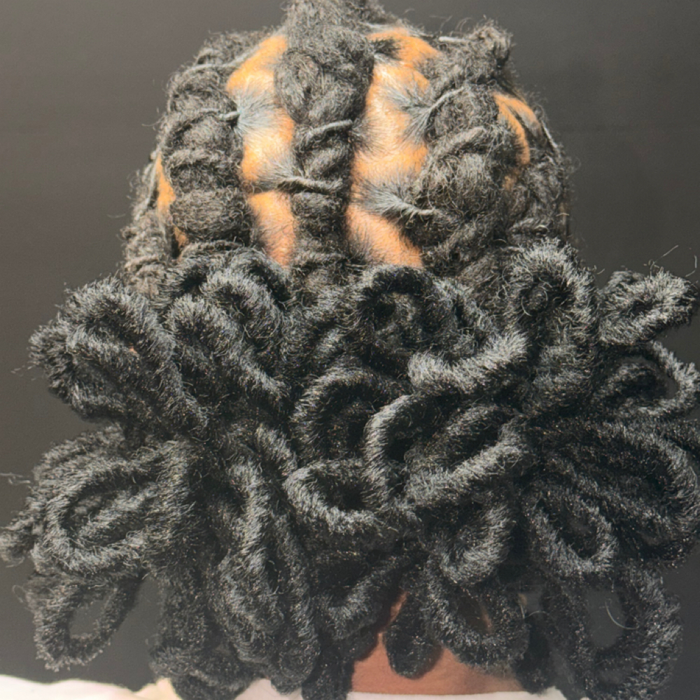 Faux Loc Petal Bun at Crowned By Victoria in Birmingham, AL