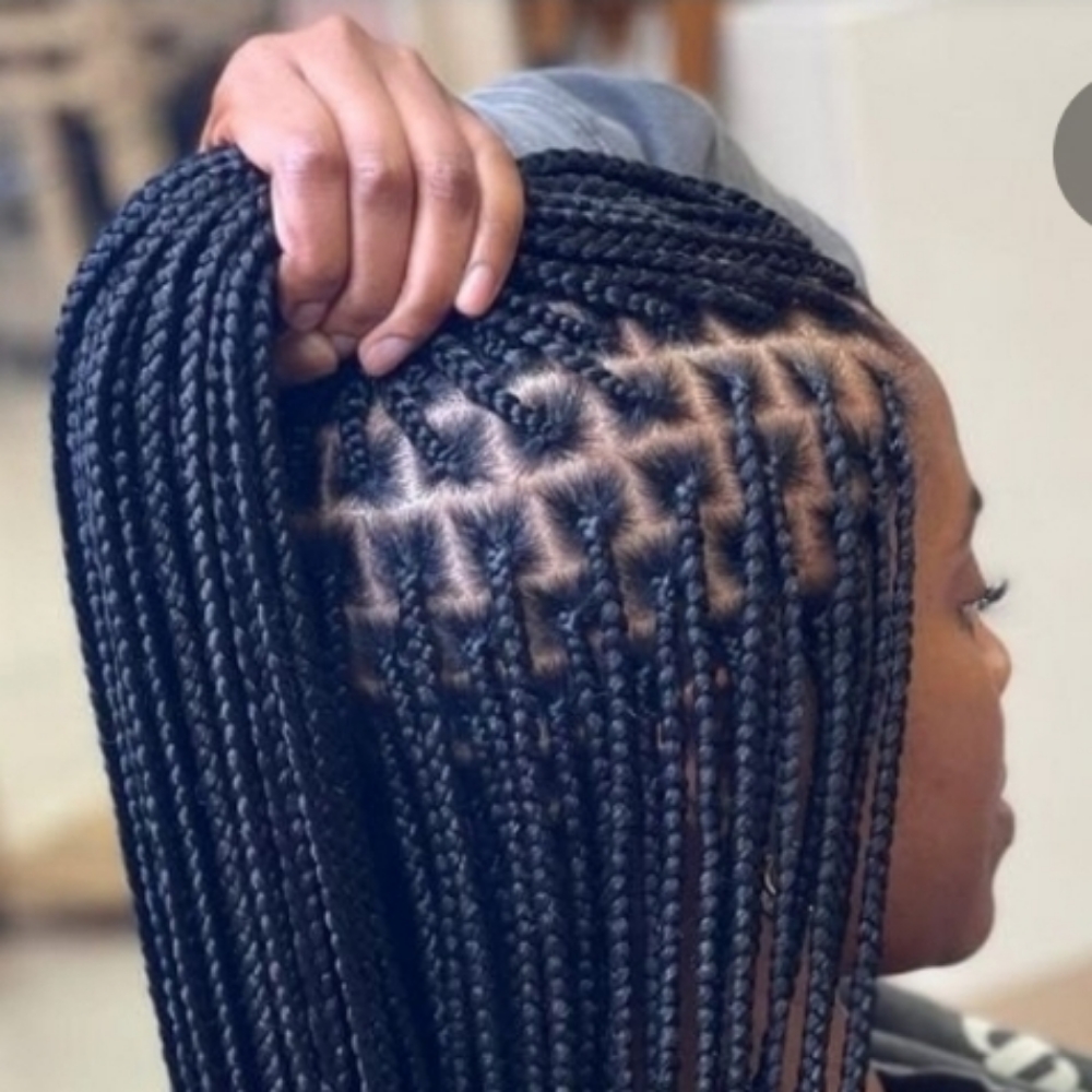 Smedium knotless mid back at ROOTS HAIR By Nene in Philadephia, PA