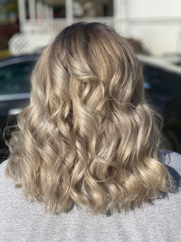 Curling entire hair at Amber Leigh’s Hair Studio in Levittown, PA