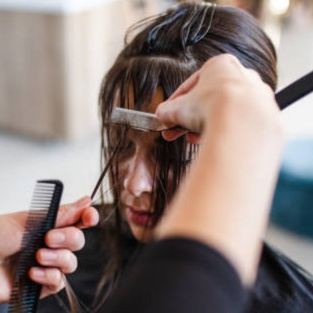 Bang trim at Blossoms HTX Hair Studio in Spring, TX